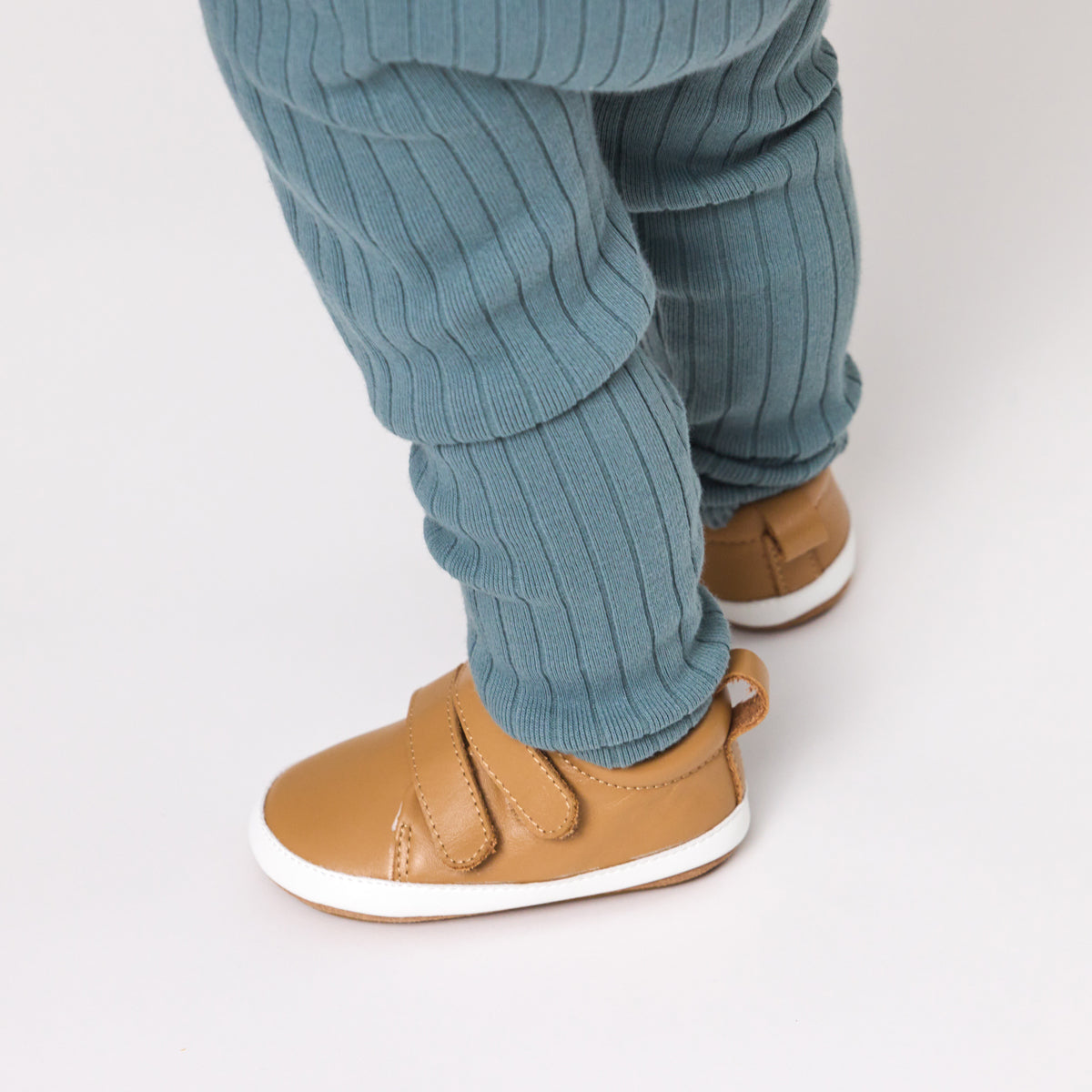 Unisex Baby Scout in tan from Pretty Brave on a baby feet