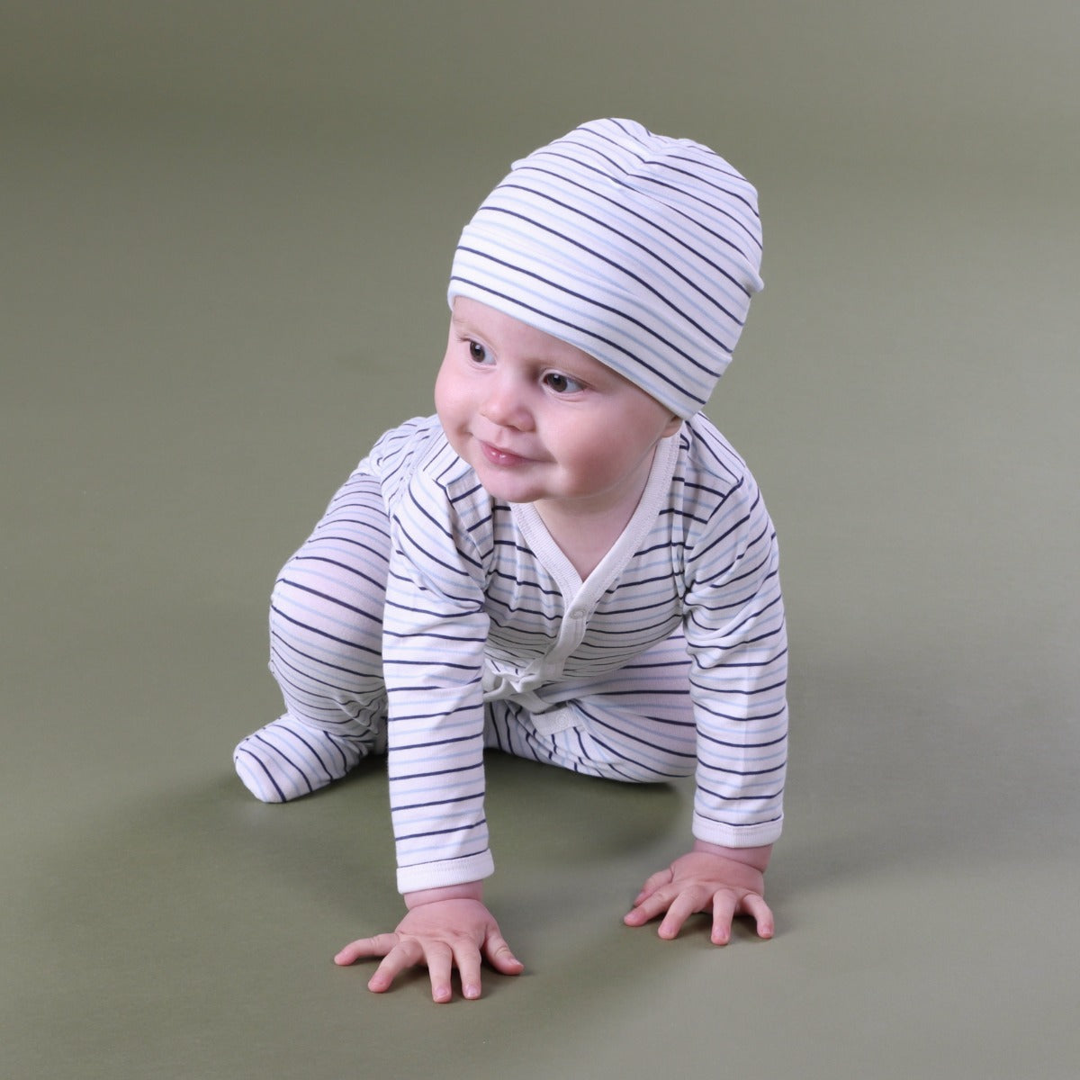 Kid crawling wearing Blue Striped cotton beanie and baby grow
