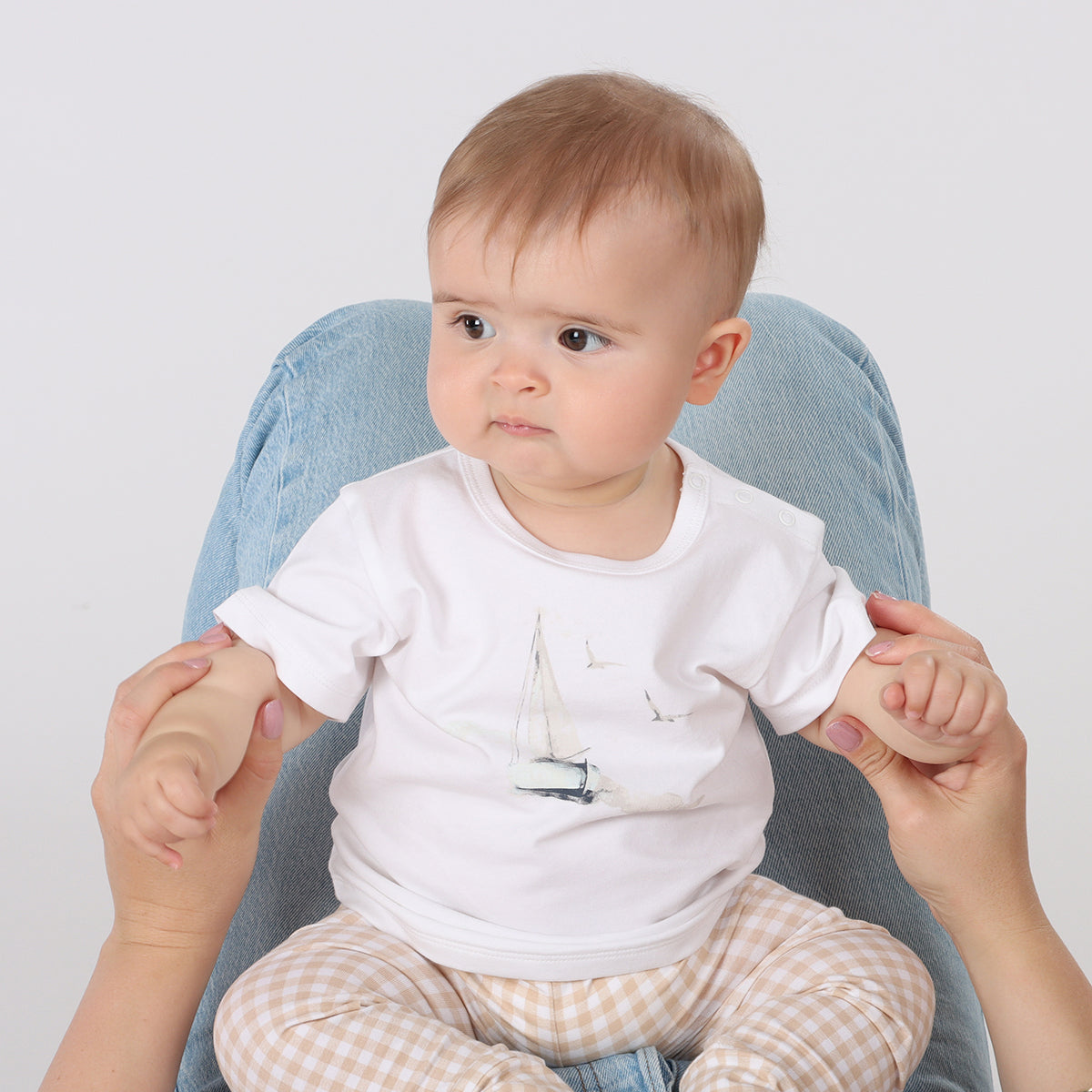 Baby playing with mother wearing Organic cotton T-shirt  with sailing boat graphic and ghingham leggings