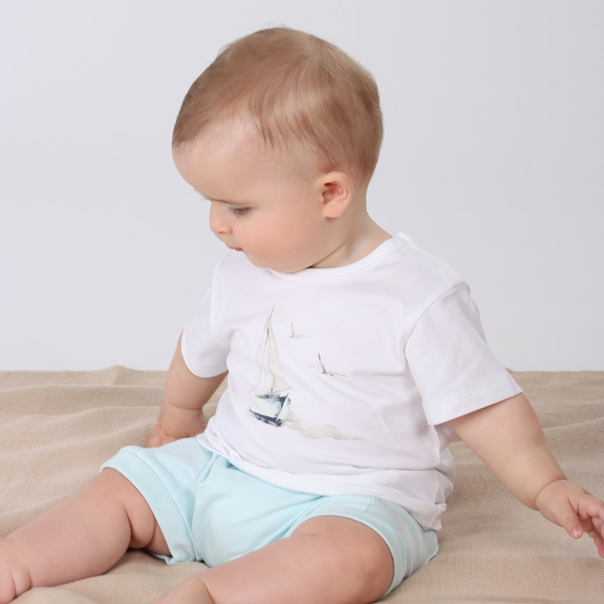 Baby wearing Organic cotton T-shirt  with sailing boat graphic with cotton shorts