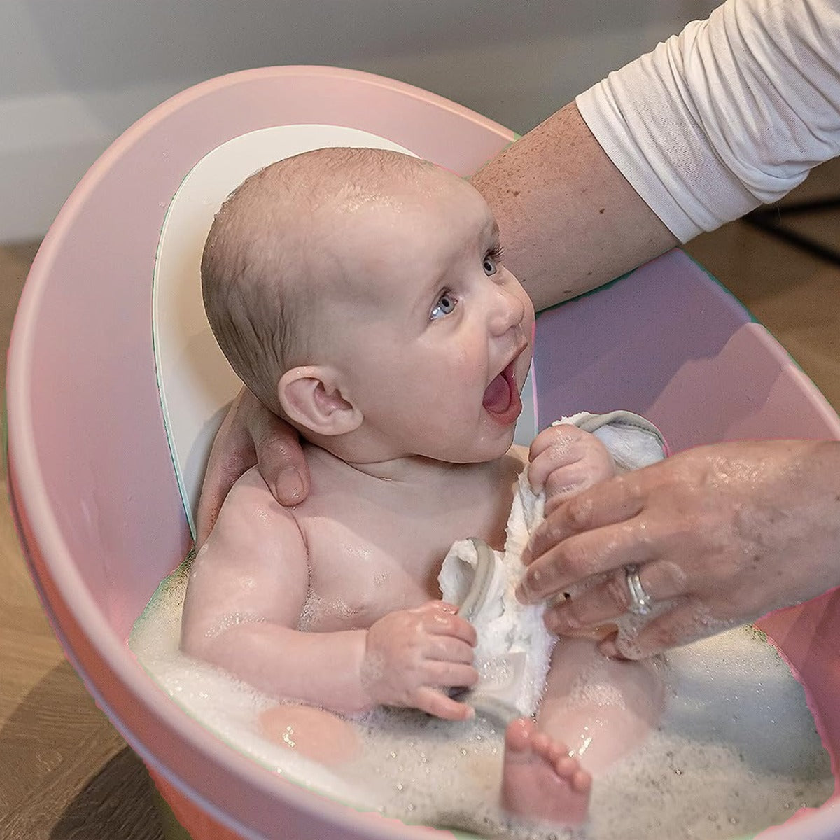 Happy child in Shnuggle Bath Blossom