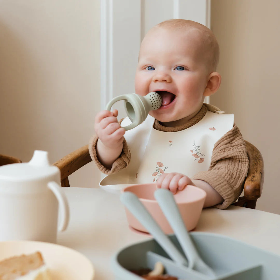 Mushie Silicone fresh food teether in Cambridge blue with baby
