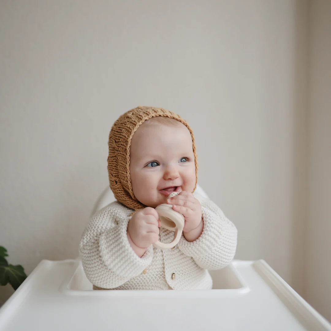 Mushie Silicone Fresh food feeder in sand with baby