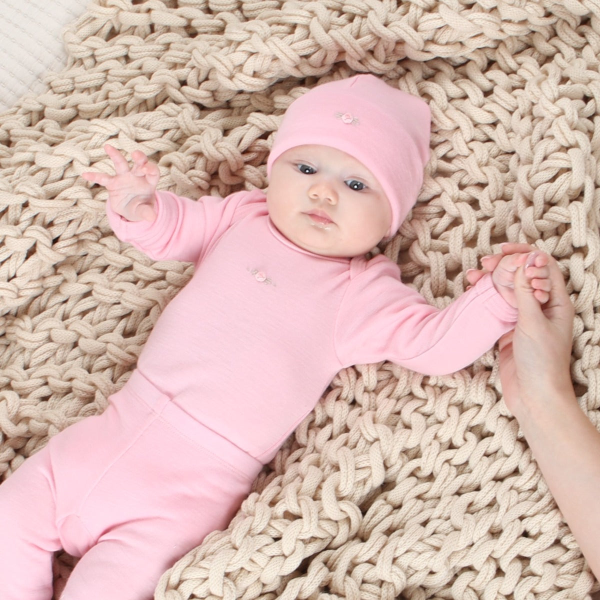 Dimples Snowglobe Merino Bodysuit Soft Pink on baby