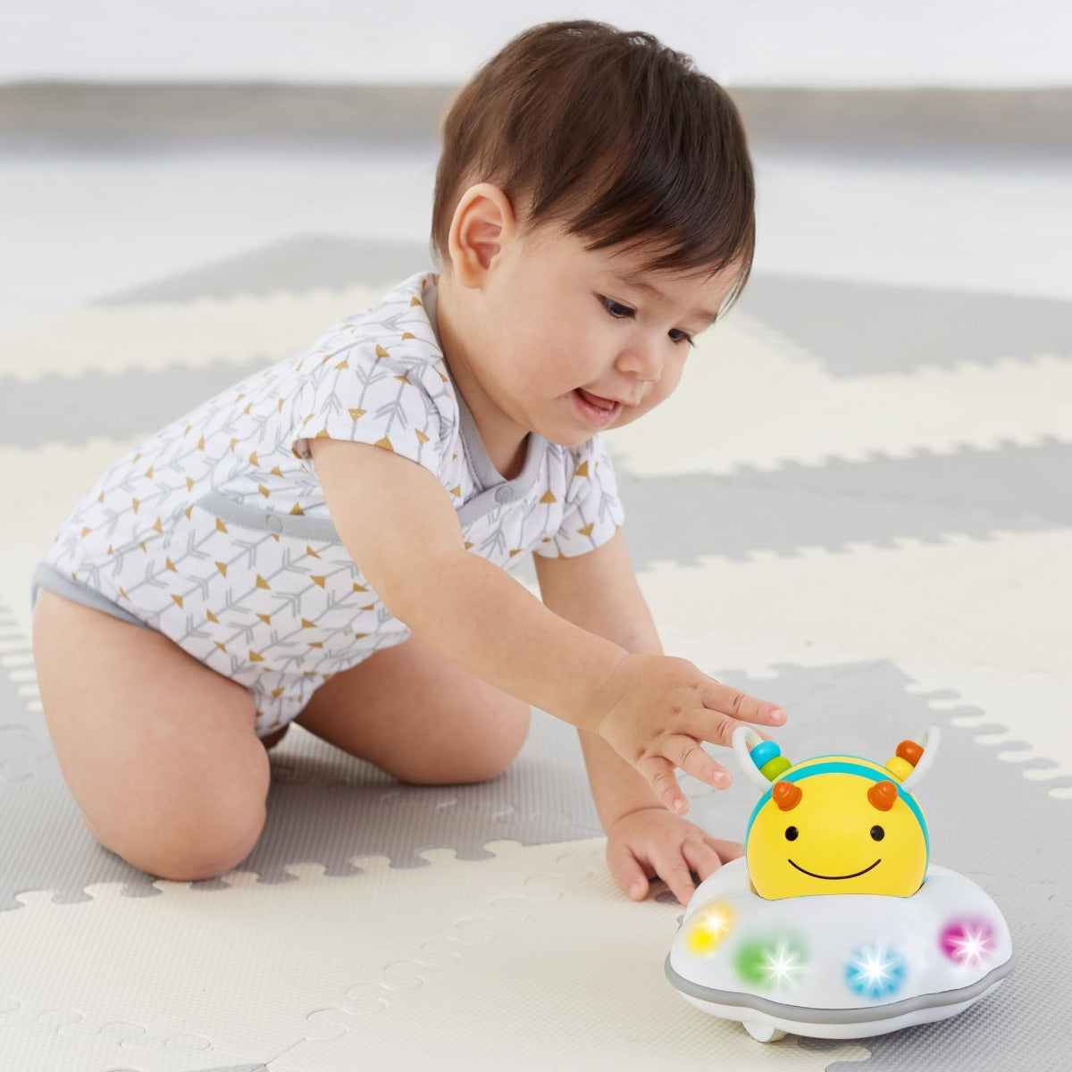 Baby playing with Explore & More Follow Me Crawl Toy from Skip Hop