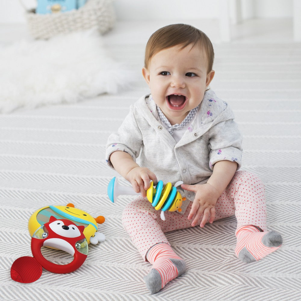 Baby playing with Explore & More Musical Instrument Set - bee rattle