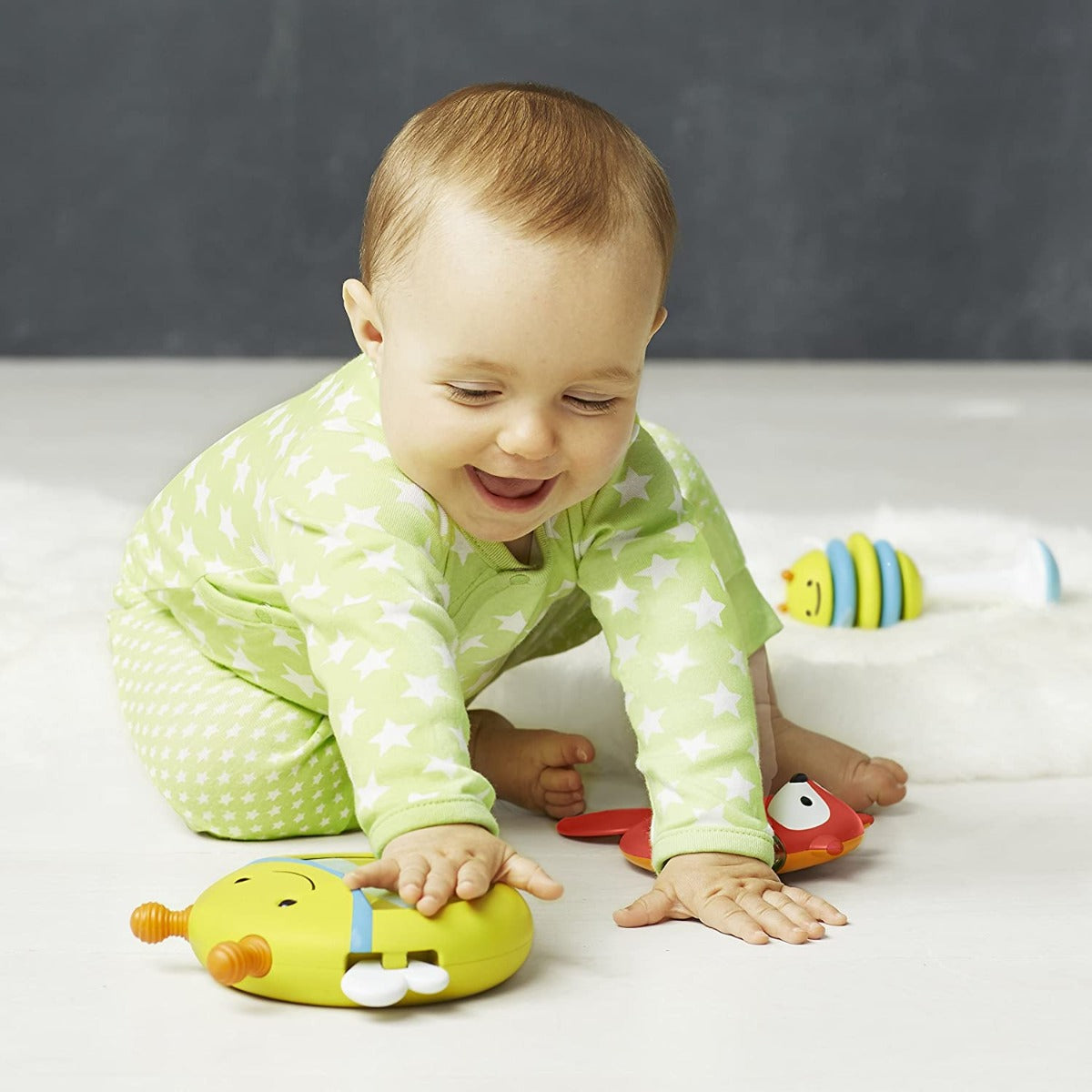 baby playing with Explore & More Musical Instrument Set fox and bee shaker