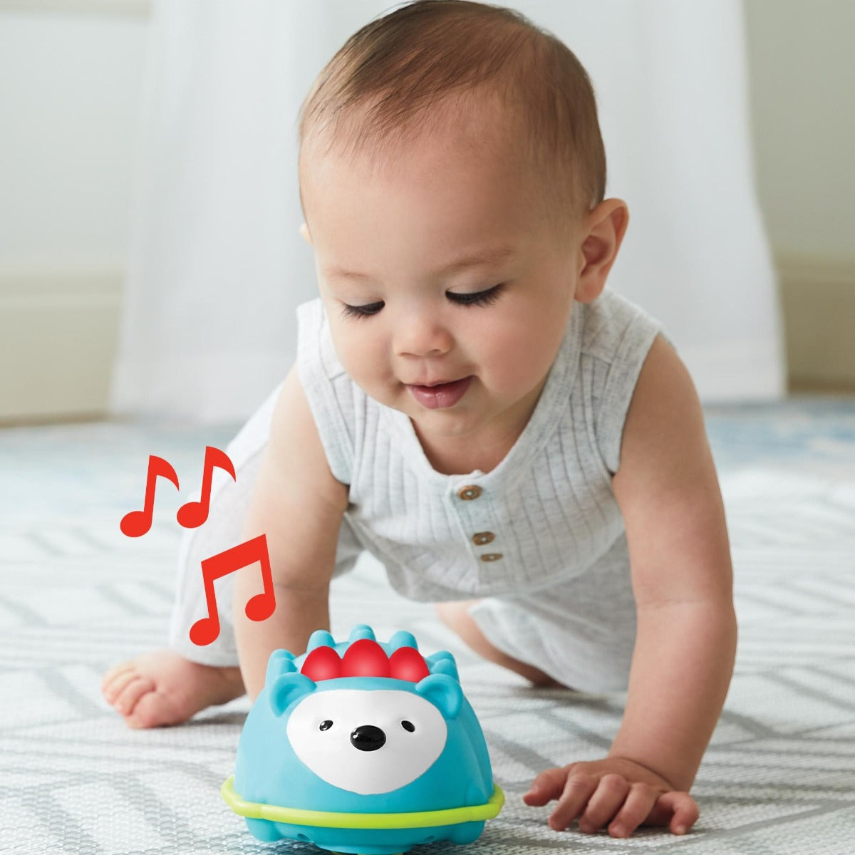 Baby crawling after Explore & More Hello Hedgehog Crawl Toy