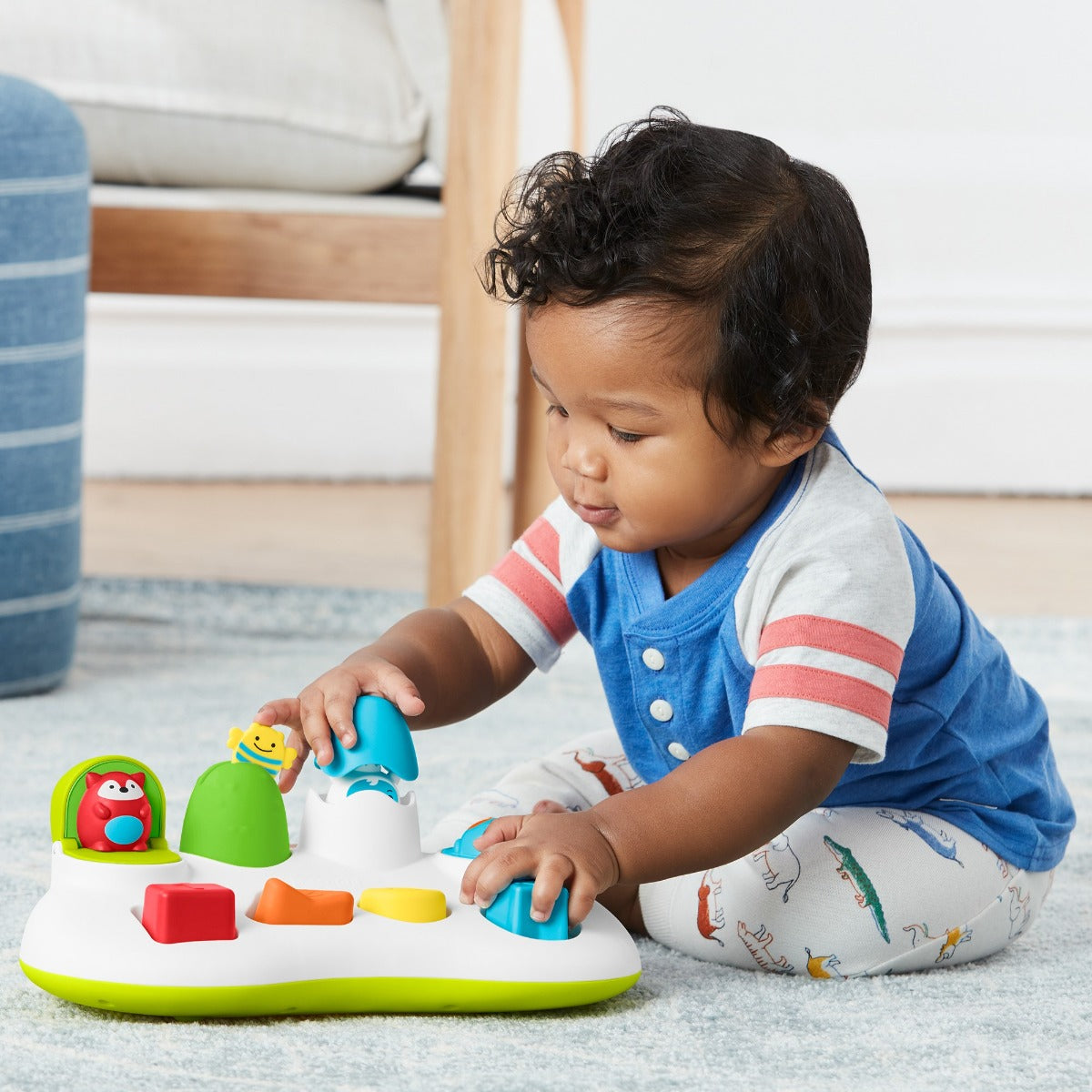 Boy playing with Explore & More Pop Up Toy from Skip Hop
