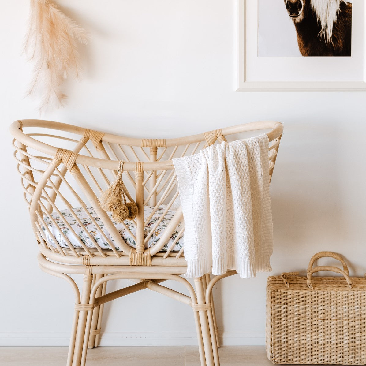Snuggle Hunny Diamond Knit Blanket in cream over cot