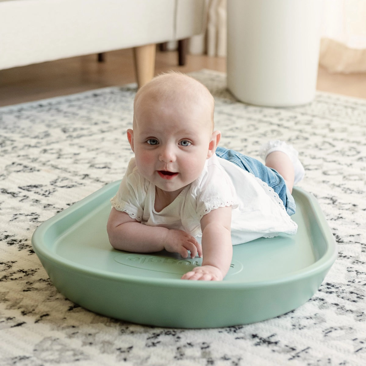 Happy child on Shnuggle Squishy Bath Mat eucalyptus