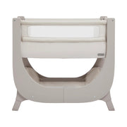 Beige baby crib with white mattress on a white background