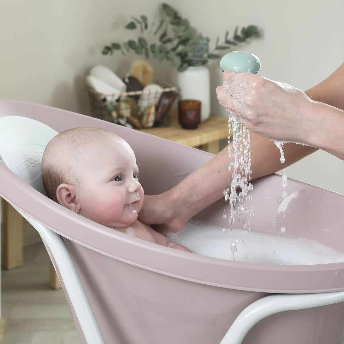 Baby having fun in shnuggle bath with octopus bath toy 