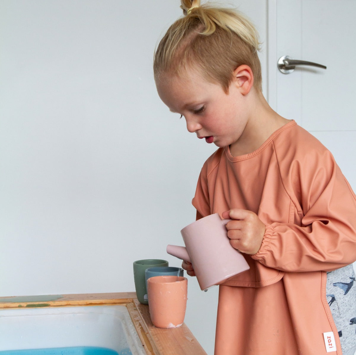 Baby girl wearing recycled polyester sleeved bib