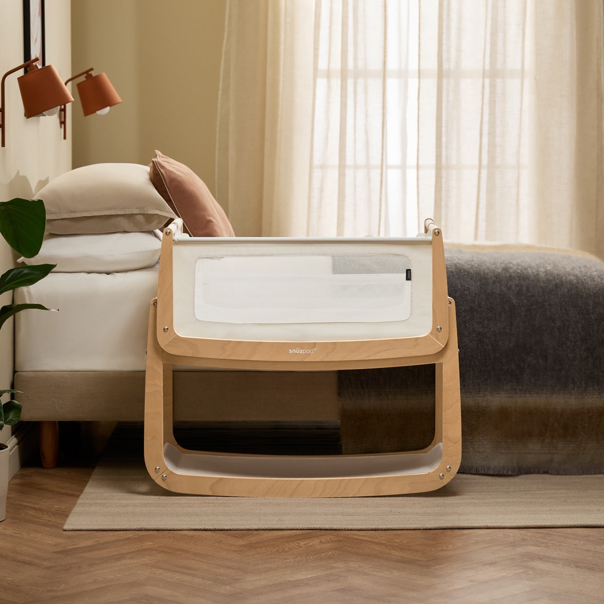 Snuzpod 5 Natural Wood Frame Bedside Baby Crib in a room