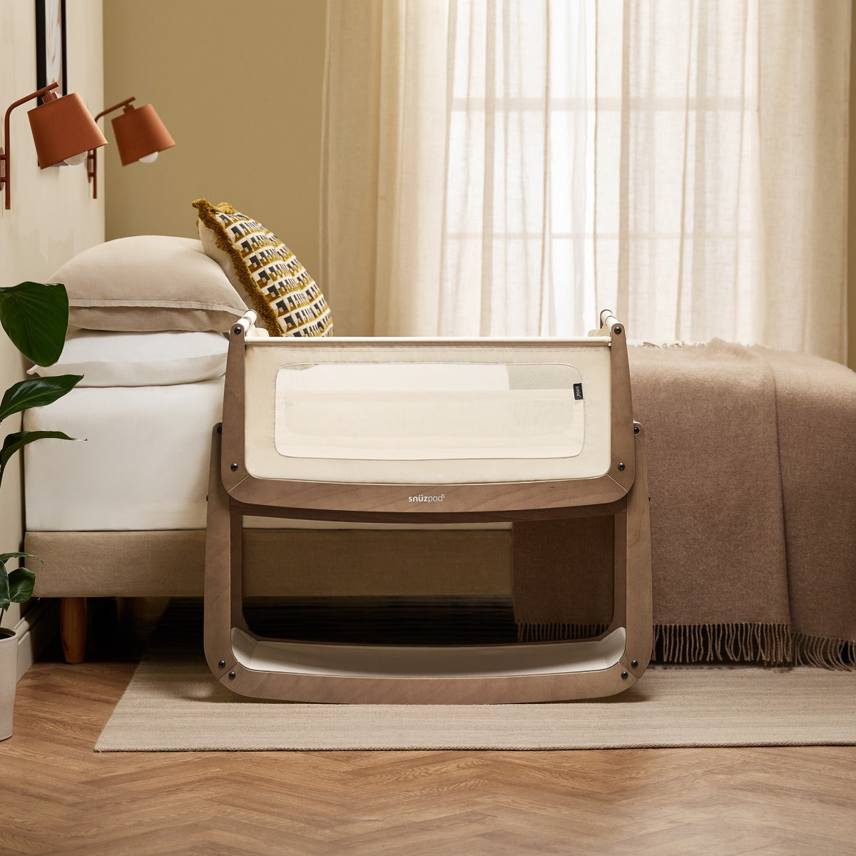 Snuzpod 5 Walnut Wood Frame Bedside Baby Crib in a room