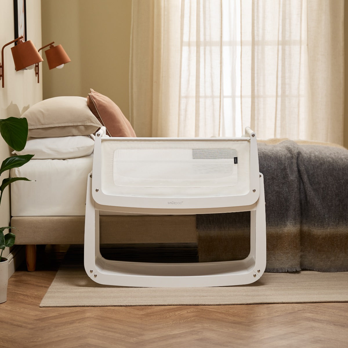 Snuzpod 5 White Wood Frame Bedside Baby Crib in a room