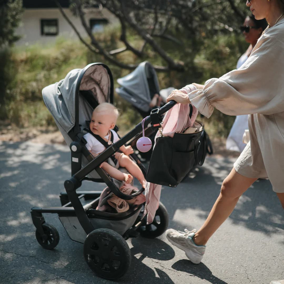 Mushie Pacifier holder in lilac lifestyle