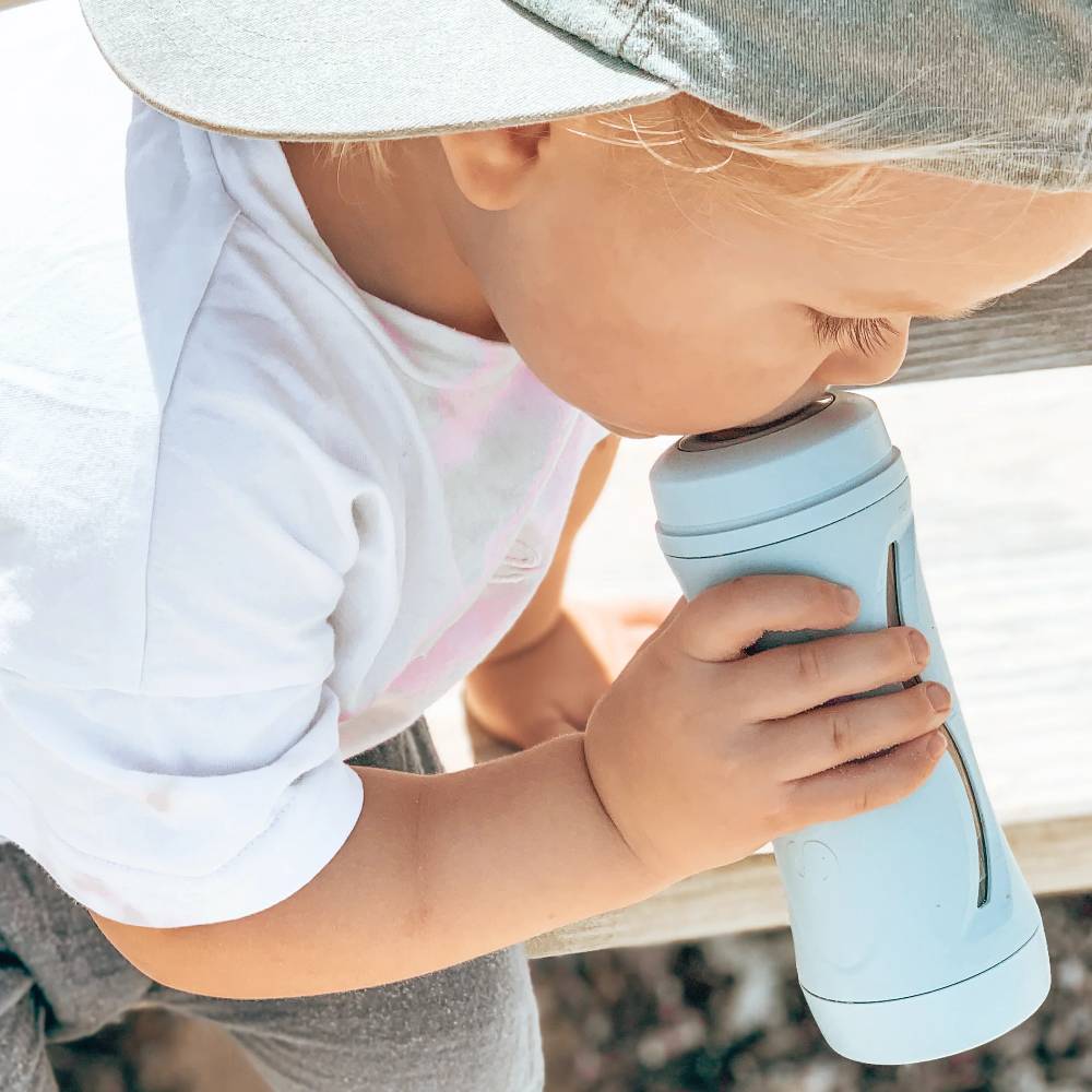 Kid using blue Subo Food Bottle