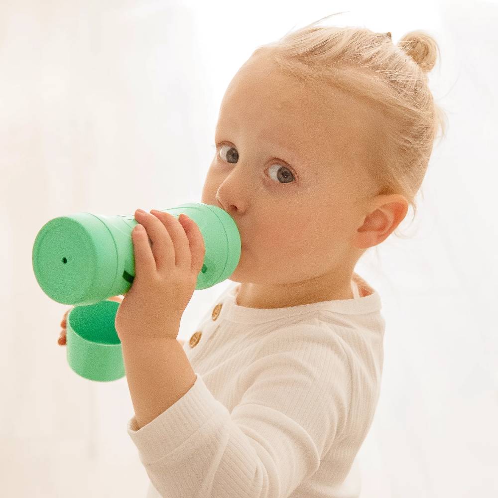 Kid using green Subo Food Bottle