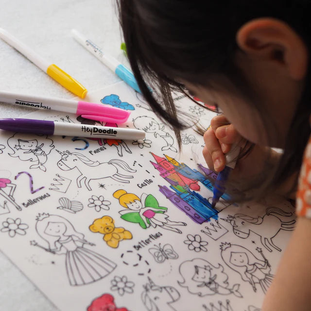 Girl colouring on Classic Sugar and Spice HeyDoodle silicone reusable colouring and doodle mat