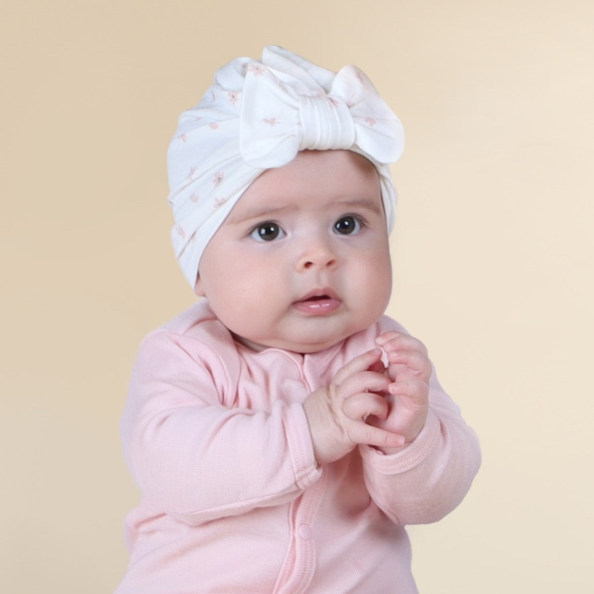 Baby Girl wearing Dainty Floral bow beanie pairing it with cardigan