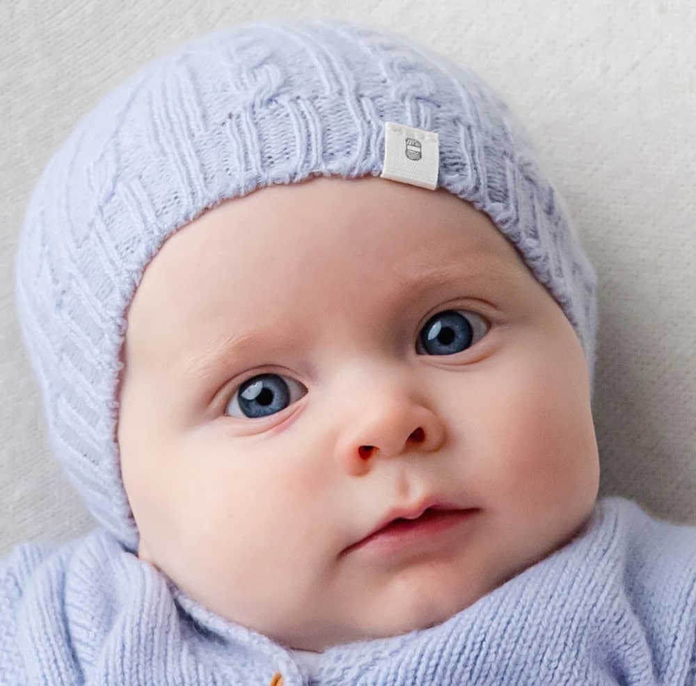 Benmore cable knit beanie in blue on baby