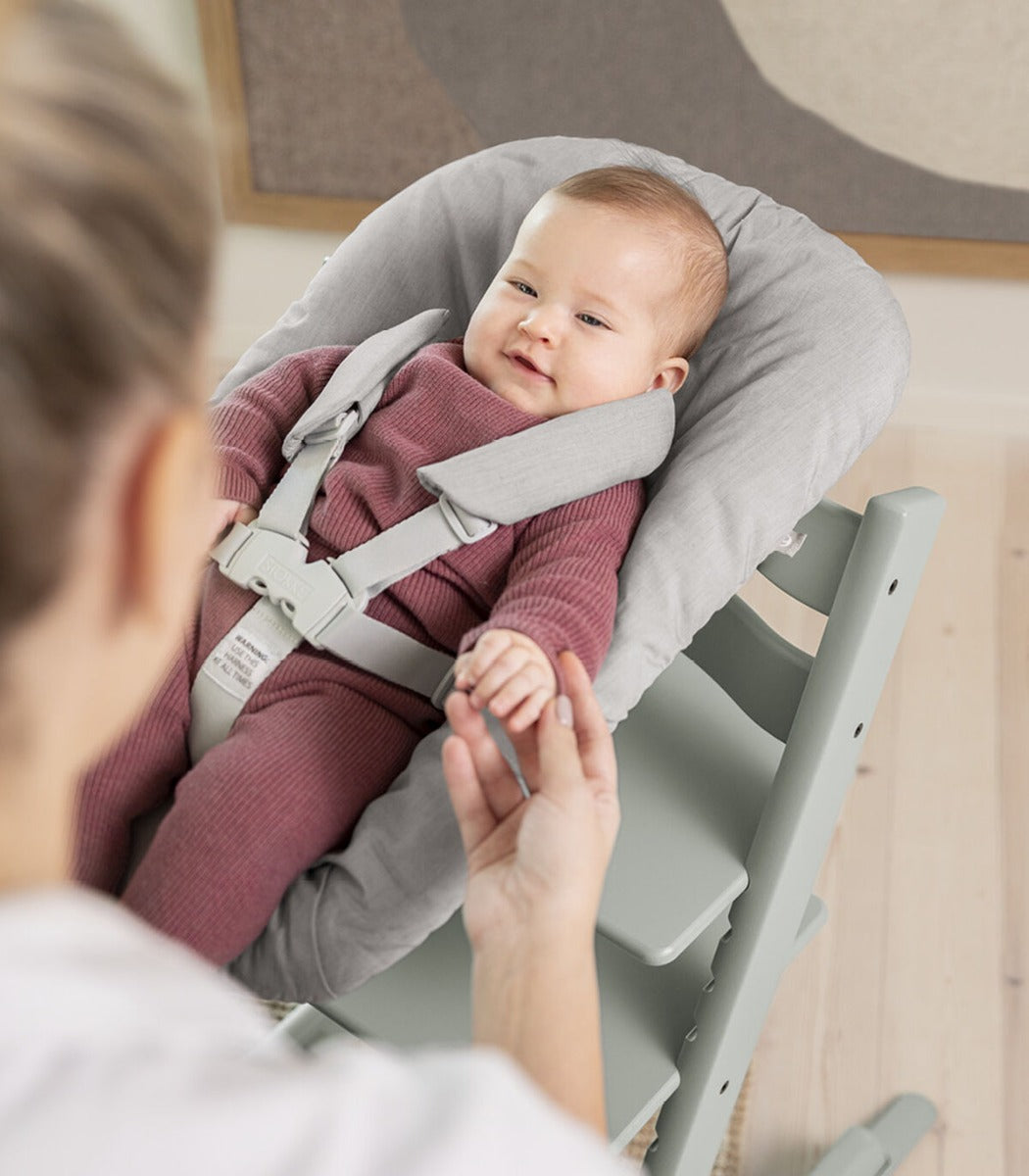 Stokke tripp trapp highchair in Glacier Green with bouncer and baby
