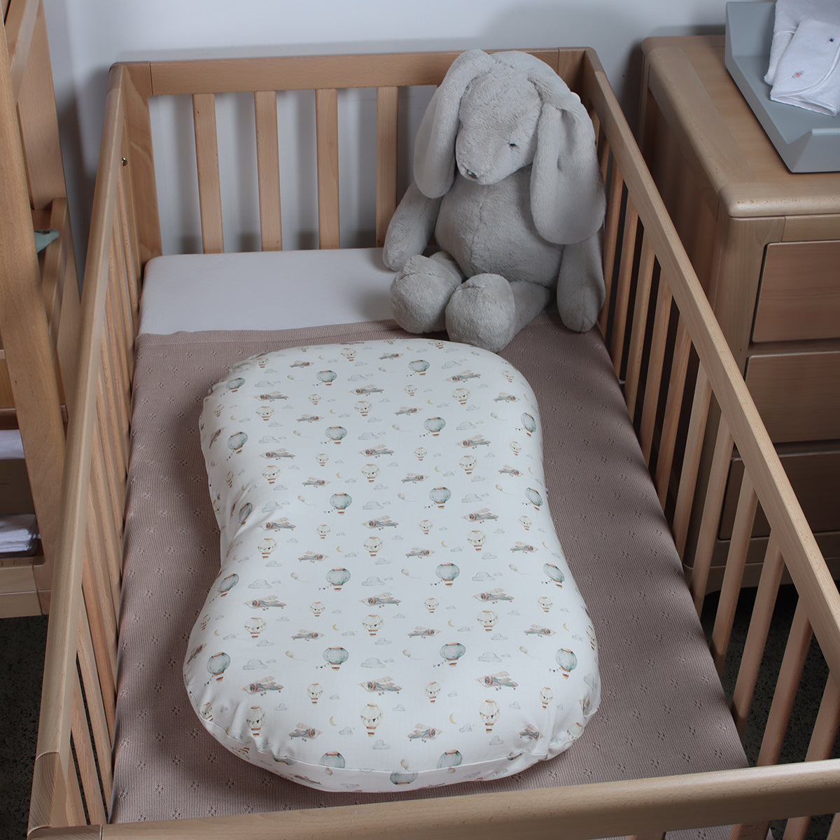 Cotton baby lounger cover on lounger in a cot