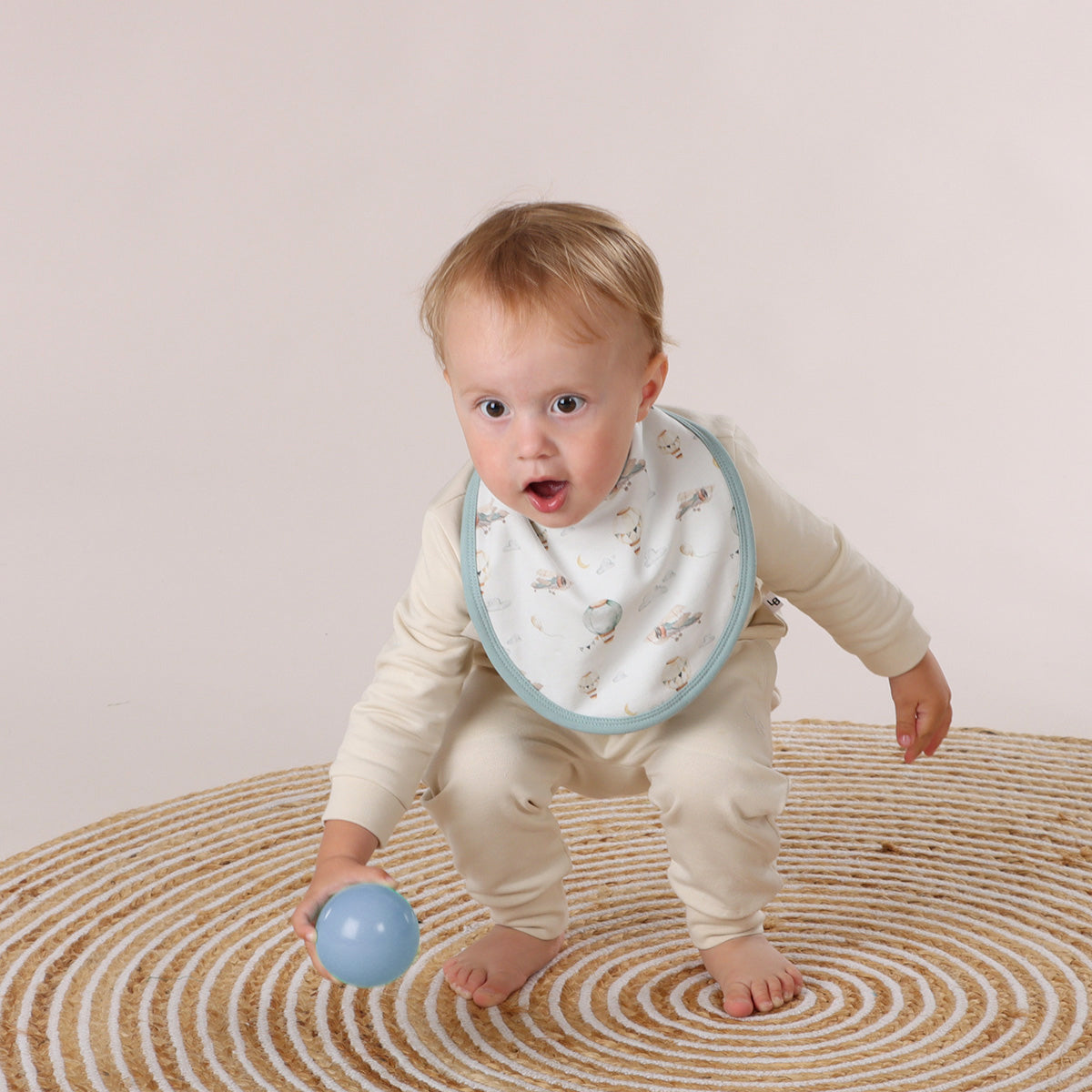 Baby wearing Embroidered Cotton Bib with balloon, plane and cloud print
