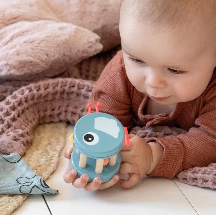 kid playing with Bell Rattle Birdee Blue done by deer