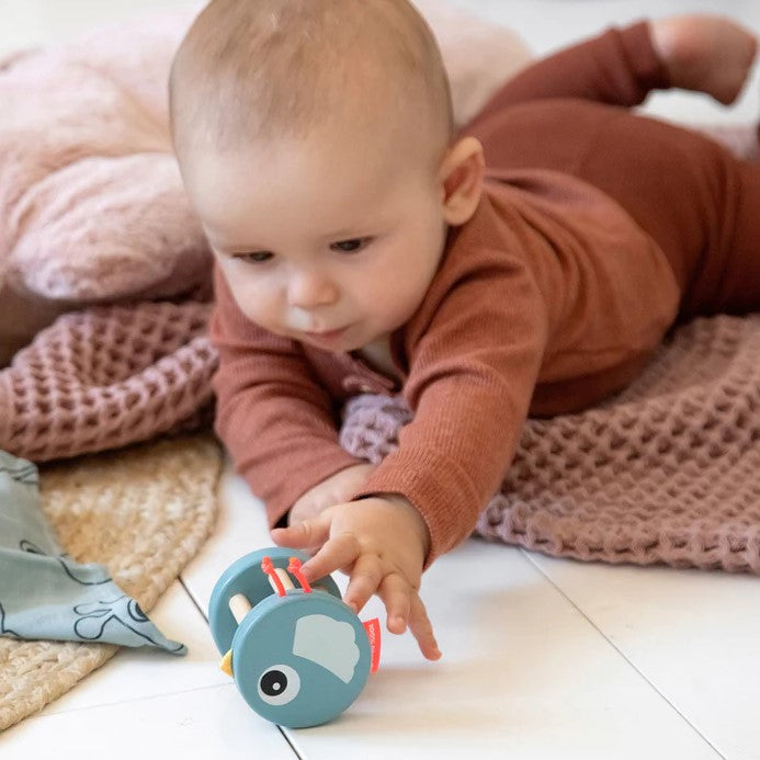 kid playing with Bell Rattle Birdee Blue done by deer lifestyle shot