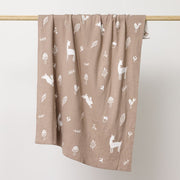 Mushroom coloured blanket with sparrows, deers, flowers and leavers printed in white hanging on the wooden rod to display.:image,small_image,thumbnail,swatch_image