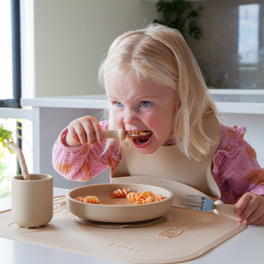 Baby eating with in silicone feeding essentials