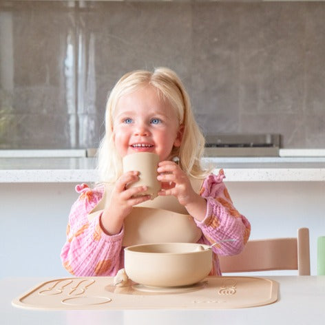 Baby eating with in silicone feeding essentials